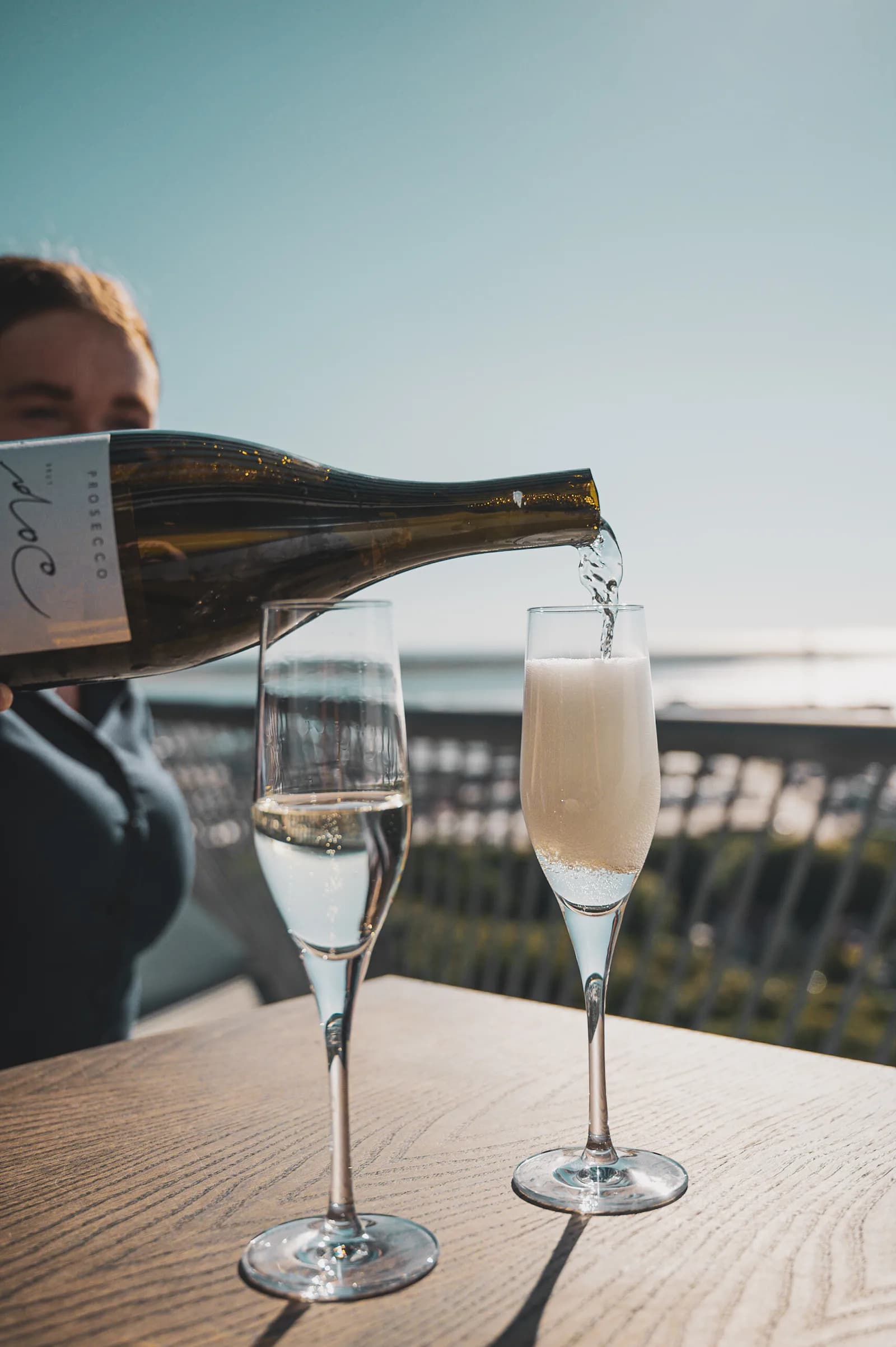 Prosecco poured on the terrace against a clear sky