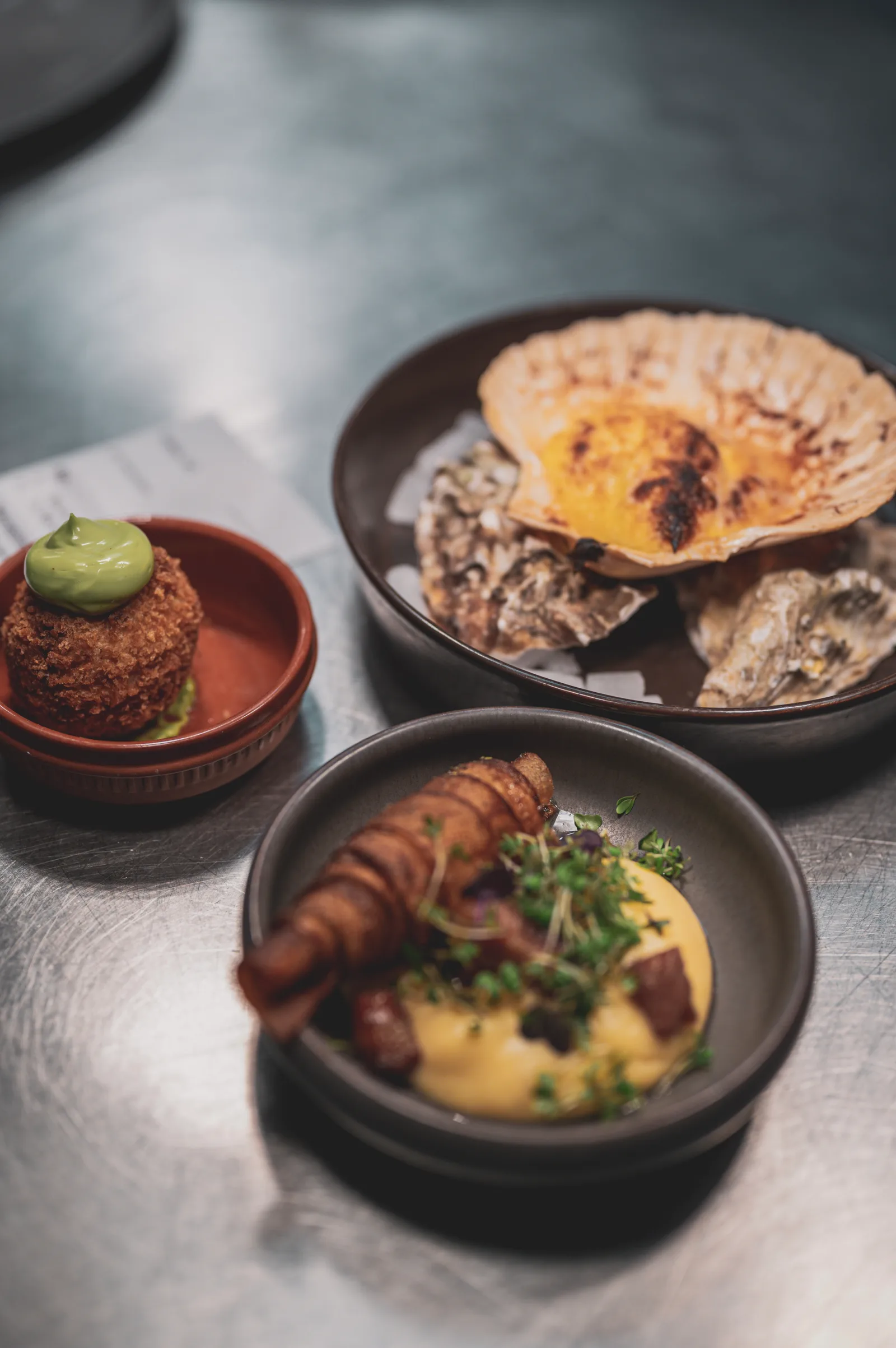 Small plates: a croquette, a scallop, a bisque